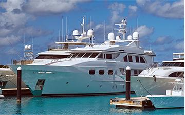 Several yachts equipped with satellite internet antennas parked at the dock